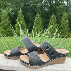 Wedge sandal in good used condition with buckle and flower detail